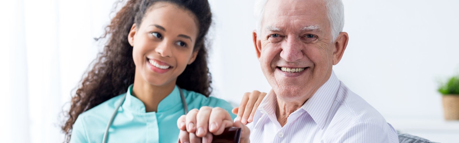 nurse taking care of senior smiling men with walking stick