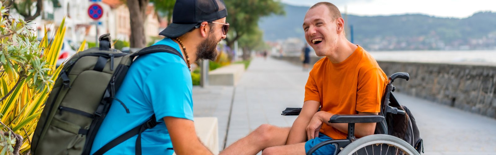 person in wheelchair with friends on summer vacation having fun